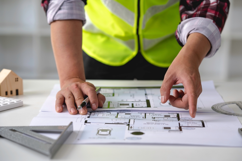 An architect reviews a set of building plans. 