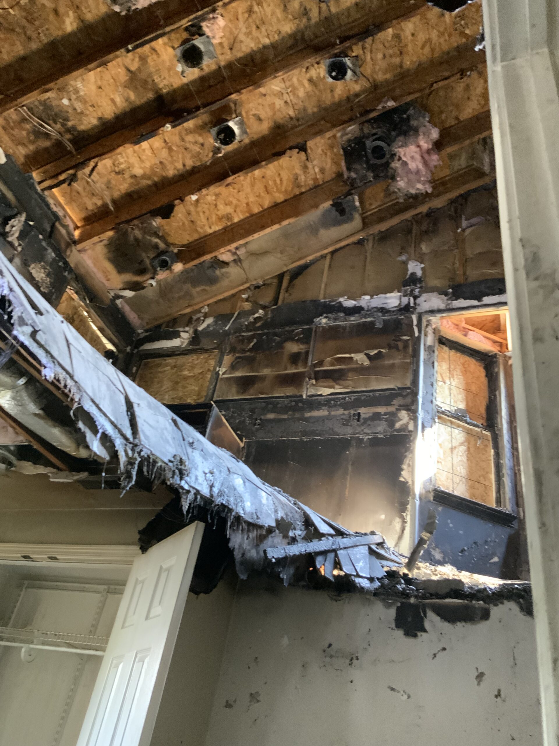 Floor showing hole and structural damage from fire.