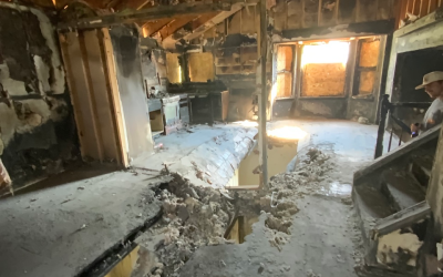 Floor showing hole and structural damage from fire.