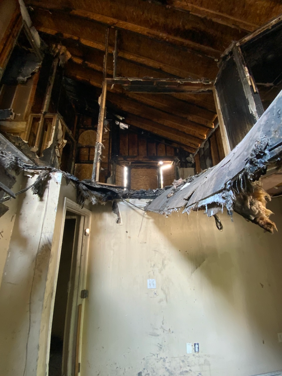 Floor showing hole and structural damage from fire.