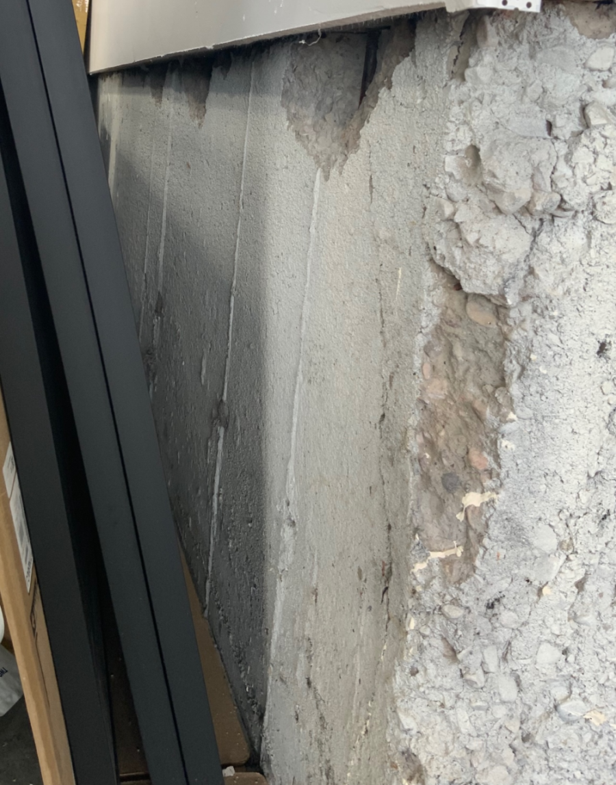 Foundation showing cracks from fire damage and weakened structurally.