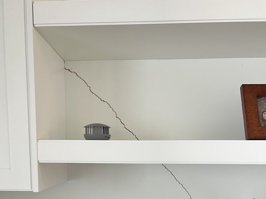 Large crack in drywall due to structural issues.