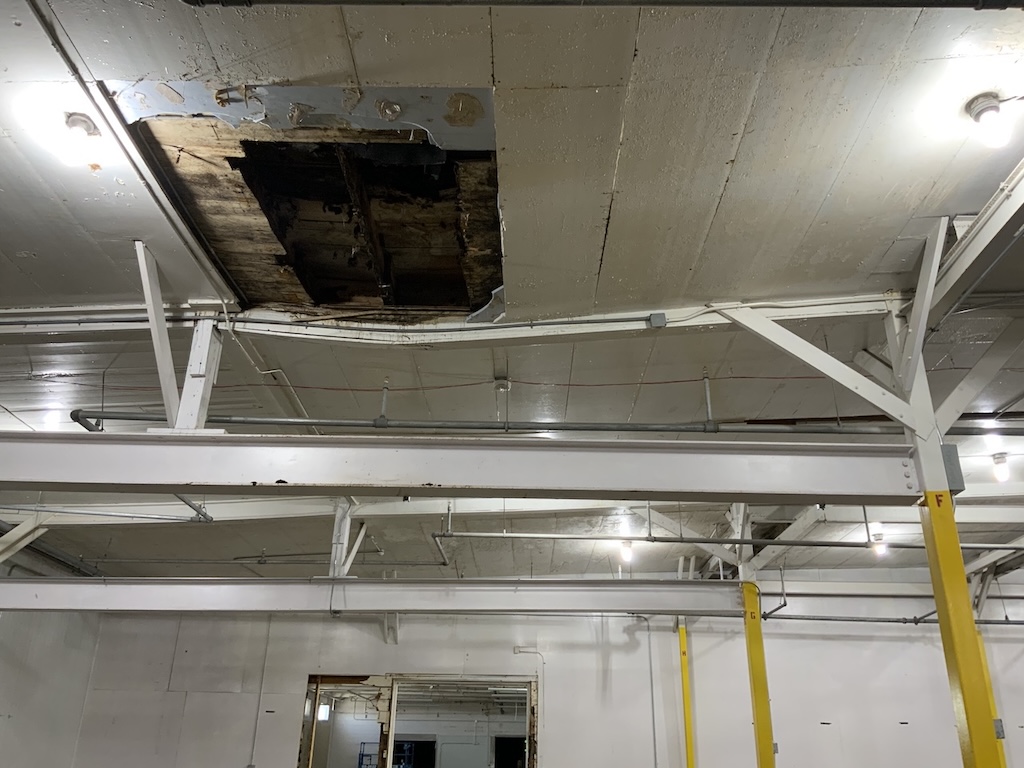 Water saturated steel beam sagging due to structural damage