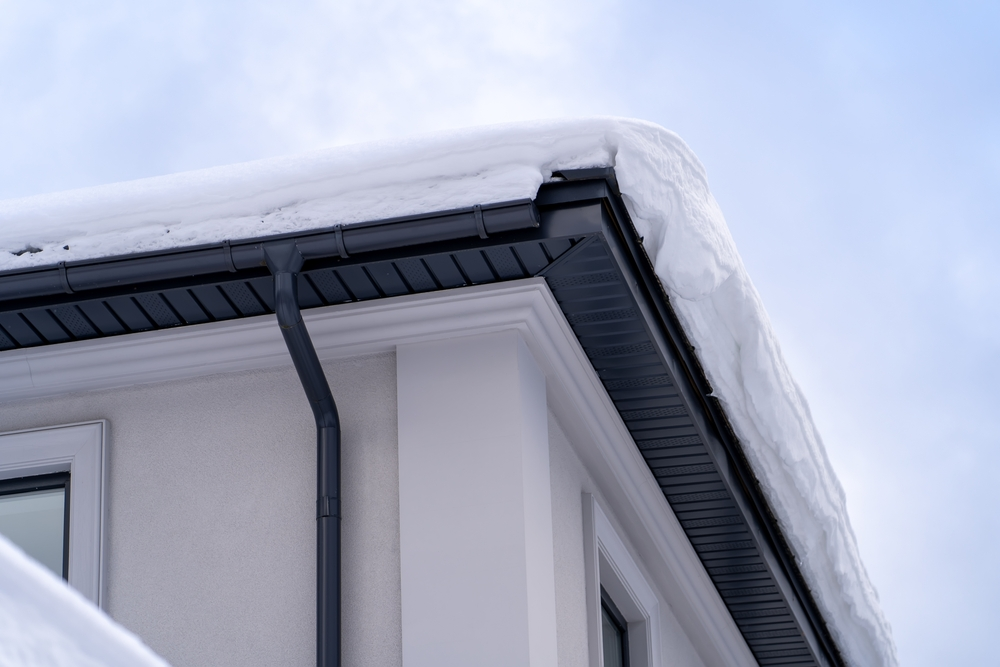 Home with snow piled on roof