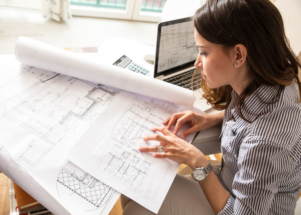 Architect or Home Designer looks over house plans.