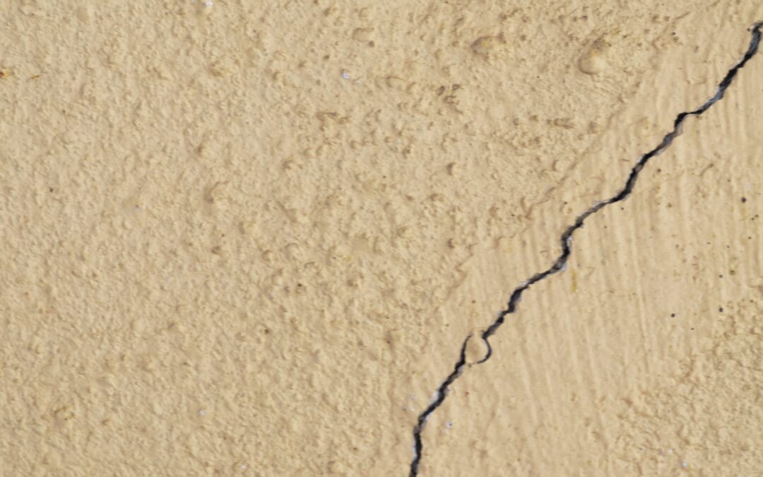 Stucco wall with a crack in it.